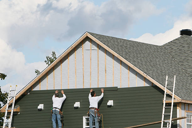 Professional Siding technician working in Port Jefferson Station, NY